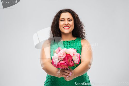 Image of happy woman in green dress with flower bunch