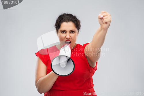 Image of woman in red dress speaking to megaphone