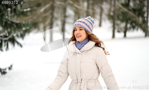 Image of happy smiling woman outdoors in winter forest