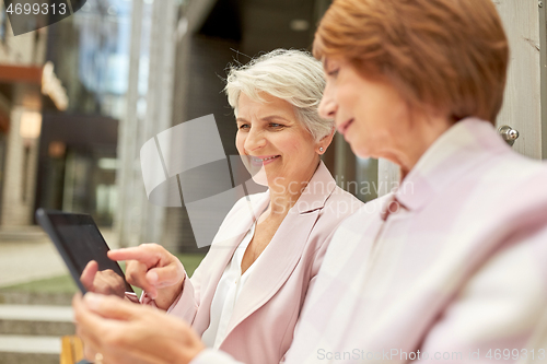 Image of senior women with tablet computer in city