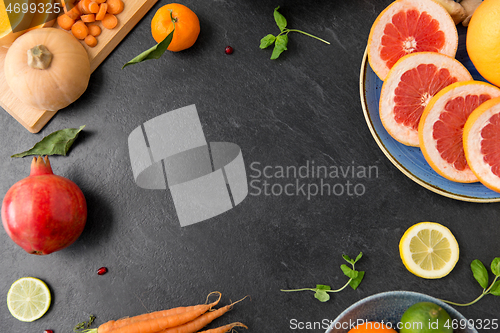 Image of different vegetables and fruits on on slate table