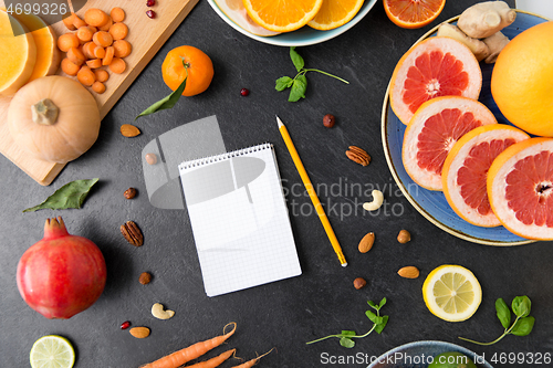 Image of close up of notebook, fruits and vegetables