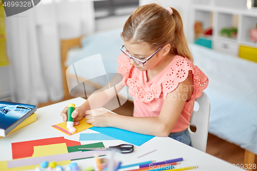 Image of creative girl making greeting card at home