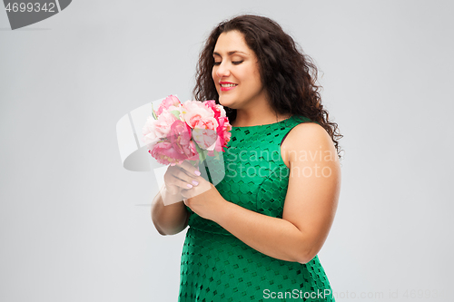 Image of happy woman in green dress with flower bunch