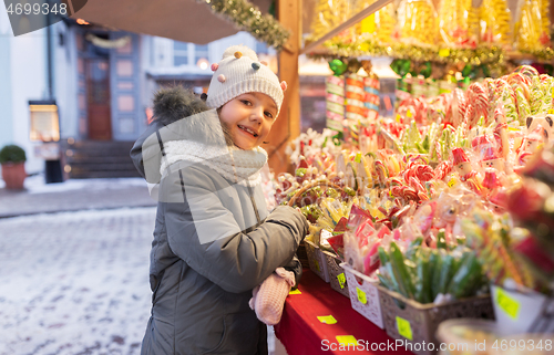 Image of little girl choosing sweets at christmas market