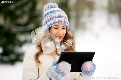 Image of woman with tablet computer outdoors in winter