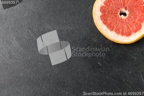 Image of close up of fresh juicy grapefruit on slate board