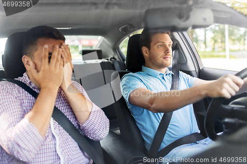 Image of car driving school instructor and male driver