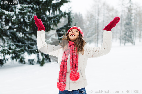 Image of happy young woman in winter park