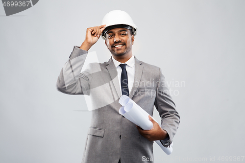 Image of indian male architect in helmet with blueprints