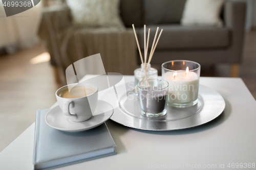 Image of coffee, candles and aroma reed diffuser on table