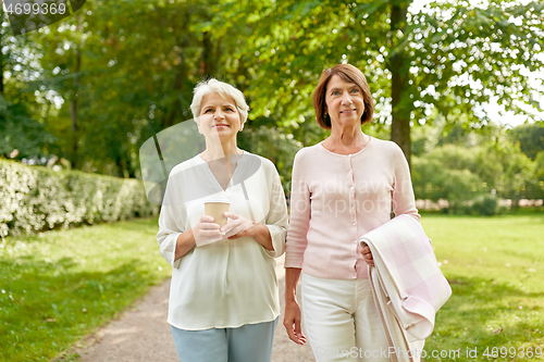 Image of senior women or friends drinking coffee at park