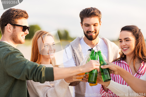 Image of friends toasting non alcoholic drinks on beach