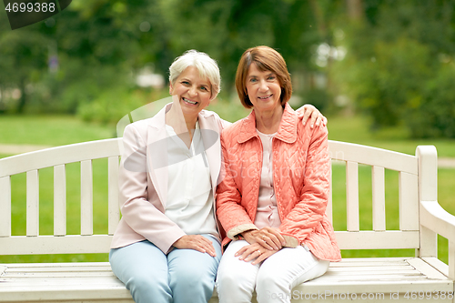Image of senior women or friends sitting on bench at park