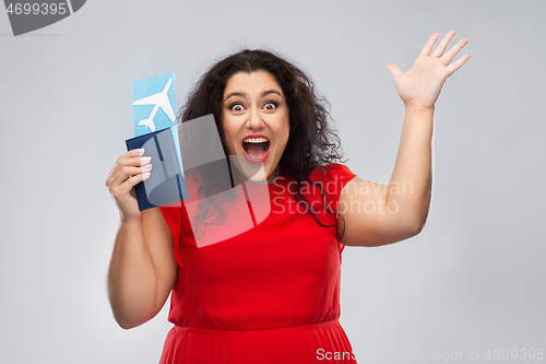 Image of happy woman with passport and air ticket