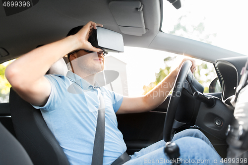 Image of man or driver wearing vr glasses and driving car