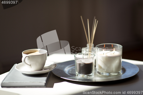 Image of coffee, candles and aroma reed diffuser on table