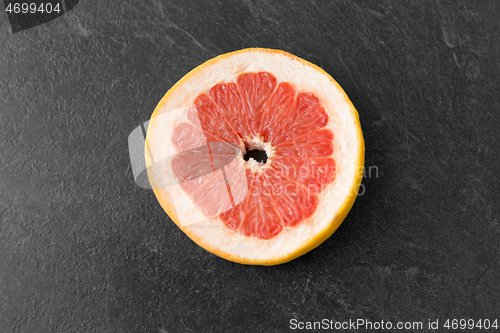 Image of close up of fresh juicy grapefruit on slate board