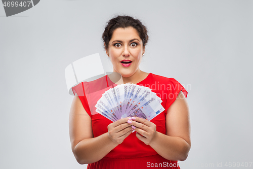 Image of happy woman holding thousands of money banknotes