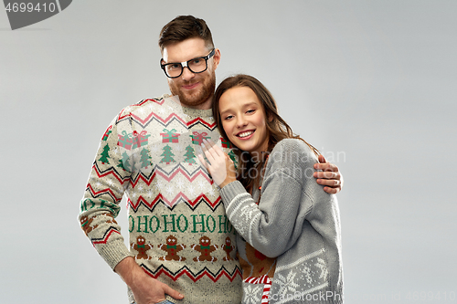 Image of happy couple at christmas ugly sweater party