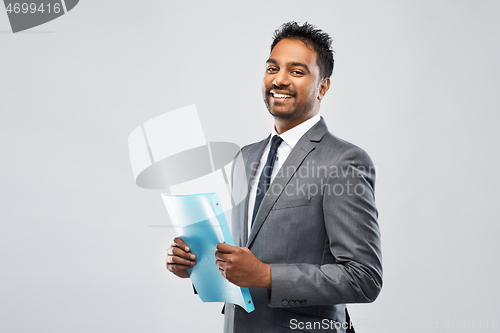 Image of indian businessman with folder over grey