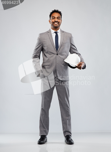 Image of indian male architect with helmet over grey