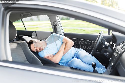 Image of tired man or driver sleeping in car