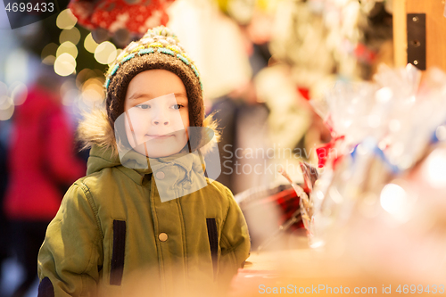 Image of happy little boy at christmas market in winter