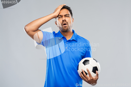 Image of upset indian male football fan with soccer ball