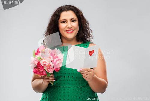 Image of happy woman with flower bunch and greeting card