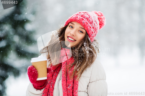 Image of happy teenage girl with coffee in winter park