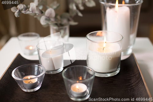 Image of burning fragrance candles on table at cozy home