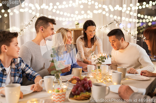 Image of happy family having birthday party at home