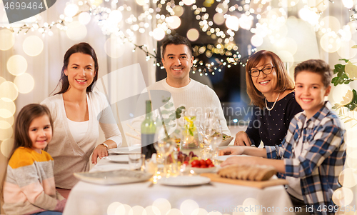 Image of happy family having dinner party at home