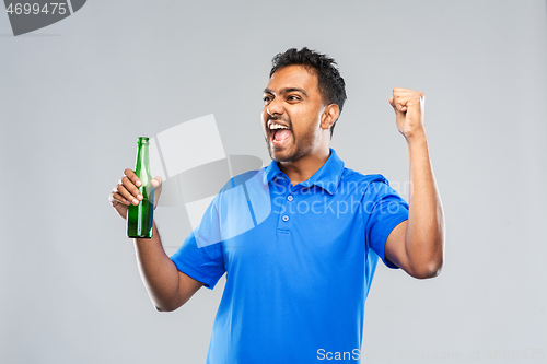 Image of male fan with beer bottle celebrating victory