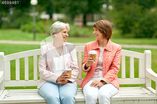 Image of senior women or friends drinking coffee at park