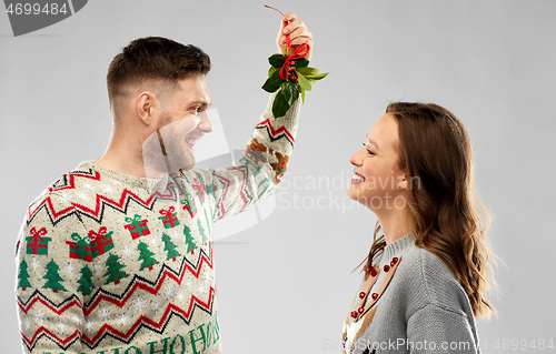 Image of happy couple standing under the mistletoe
