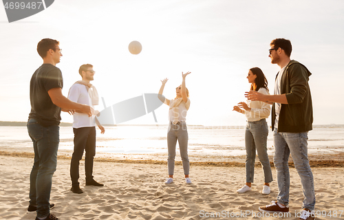 Image of friends playing volleyball on beach in summer