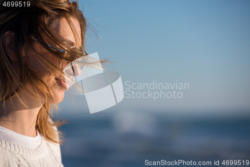 Image of Young woman enjoying the warm autumn day