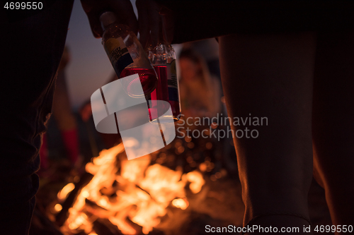 Image of Friends having fun at beach on autumn day