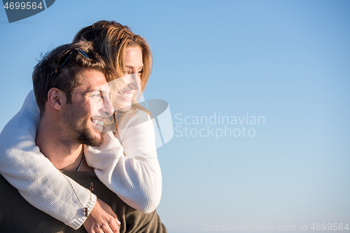 Image of couple having fun at beach during autumn