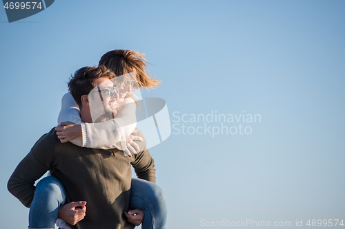 Image of couple having fun at beach during autumn