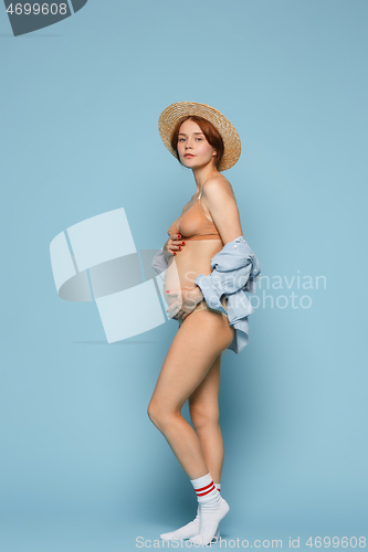 Image of Young beautiful pregnant woman posing on blue background