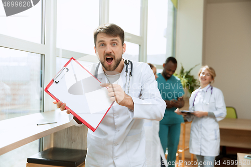 Image of Beautiful surprised doctor over hospital background