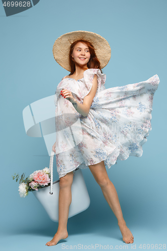 Image of Young beautiful pregnant woman posing on blue background