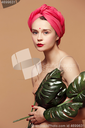 Image of Young beautiful pregnant woman posing on brown background