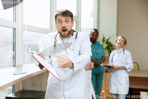 Image of Beautiful surprised doctor over hospital background