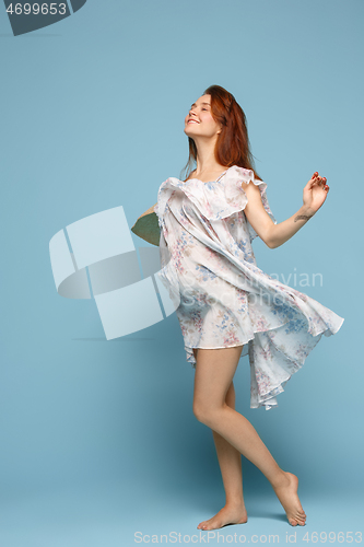 Image of Young beautiful pregnant woman posing on blue background