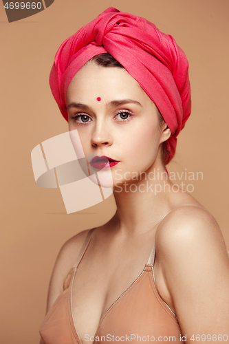 Image of Young beautiful pregnant woman posing on brown background