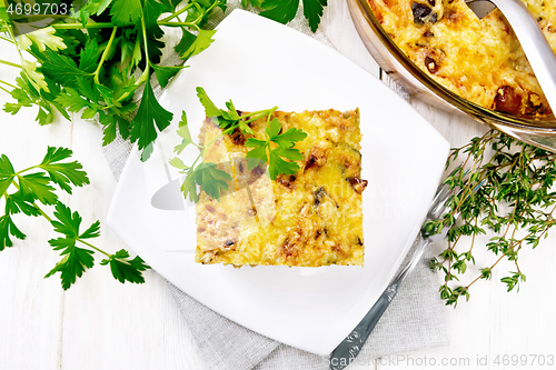 Image of Casserole of meat and eggplant in plate on board top